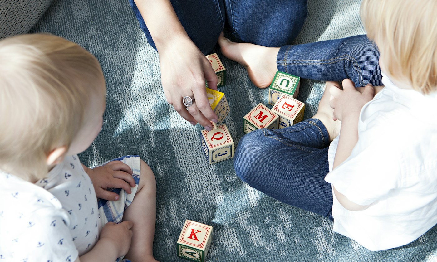 Children exploring colorful letter blocks together